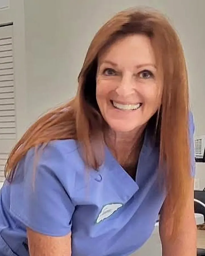 Suzanne Armstrong, certified post-operative lymphatic therapist, in clinical scrubs